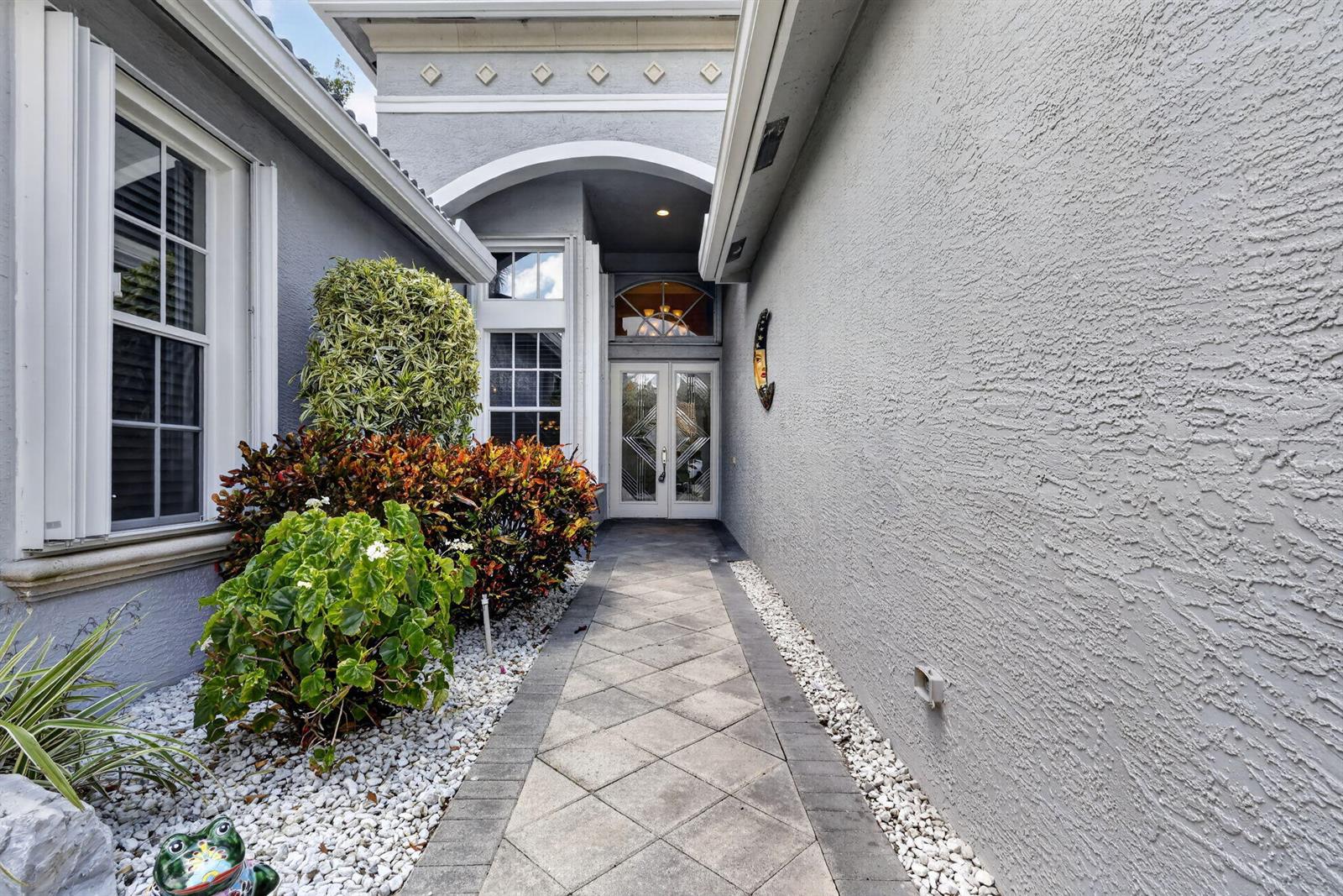 A paved walkway leads to a double front door under a covered entryway — 6550 Sand City Way, Delray Beach FL 33446, DELRAY BEACH, FL