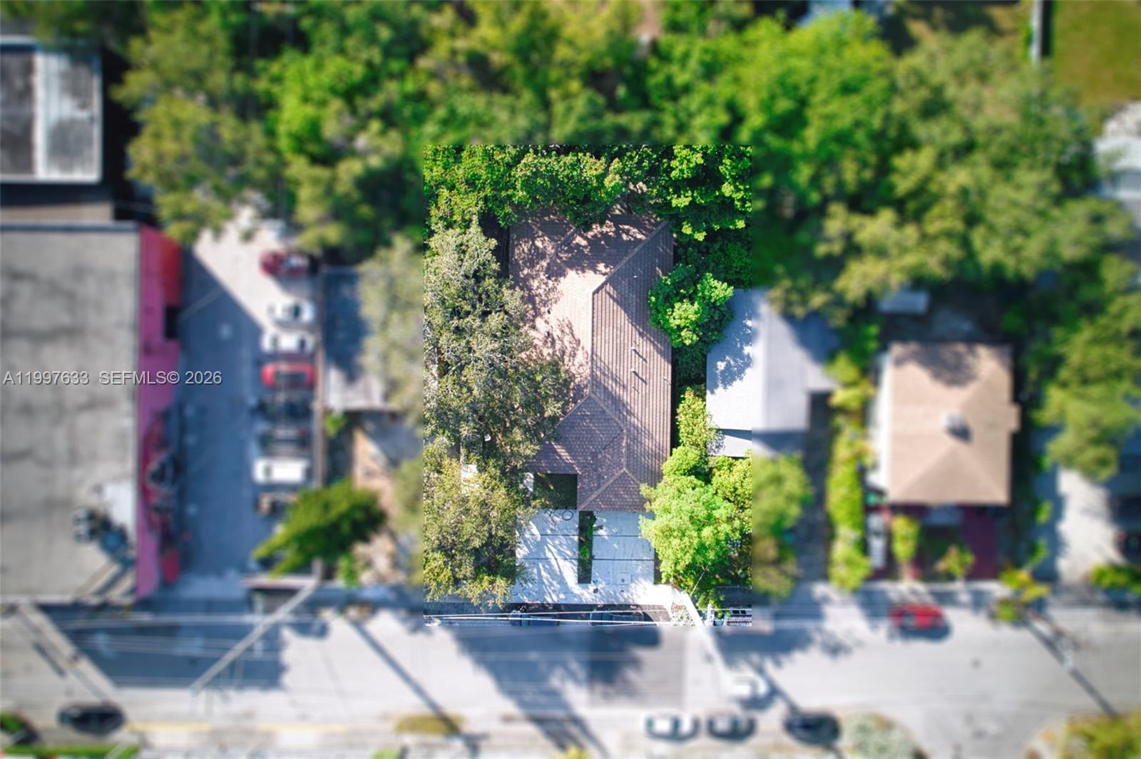 An aerial view shows a house with a brown roof surrounded by trees and pavement — 5428 NW 3rd Ave, Miami FL 33127, MIAMI, FL