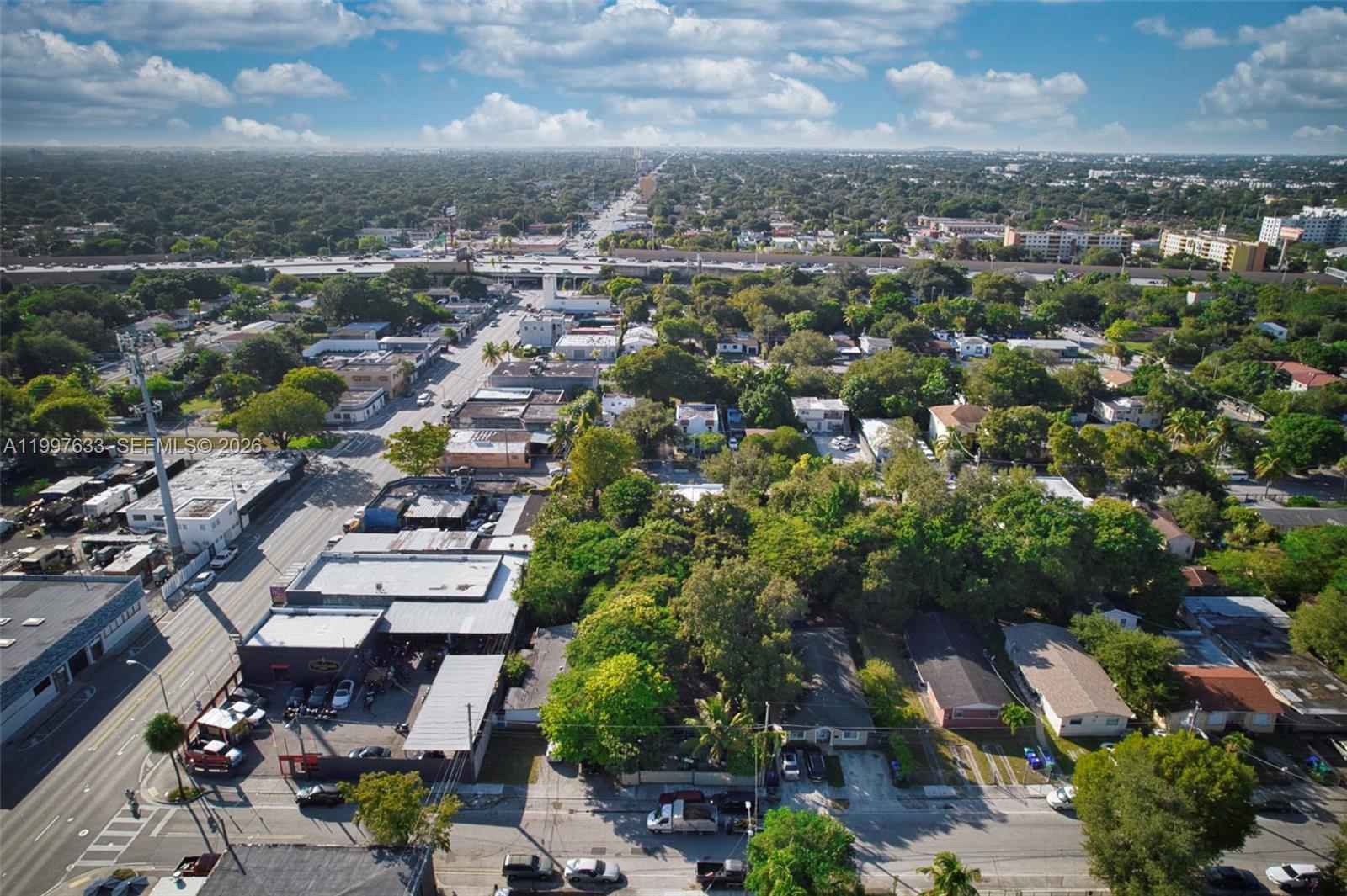 An aerial view shows a commercial street with low-rise buildings and surrounding residential neighborhoods — 5428 NW 3rd Ave, Miami FL 33127, MIAMI, FL
