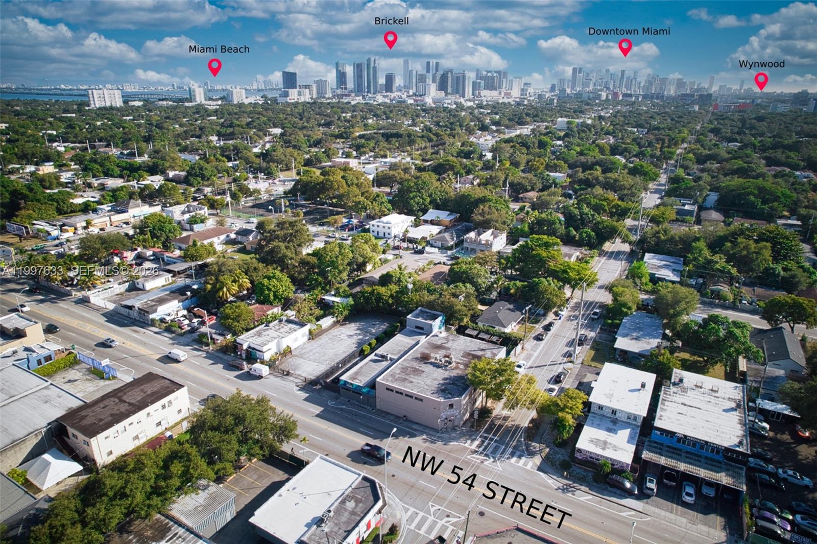 An aerial view shows a commercial building on a street corner with surrounding urban development — 5428 NW 3rd Ave, Miami FL 33127, MIAMI, FL