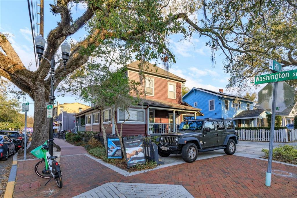 A dark red two-story building sits on a corner lot with a Jeep parked outside — 37 HILL, ORLANDO, FL