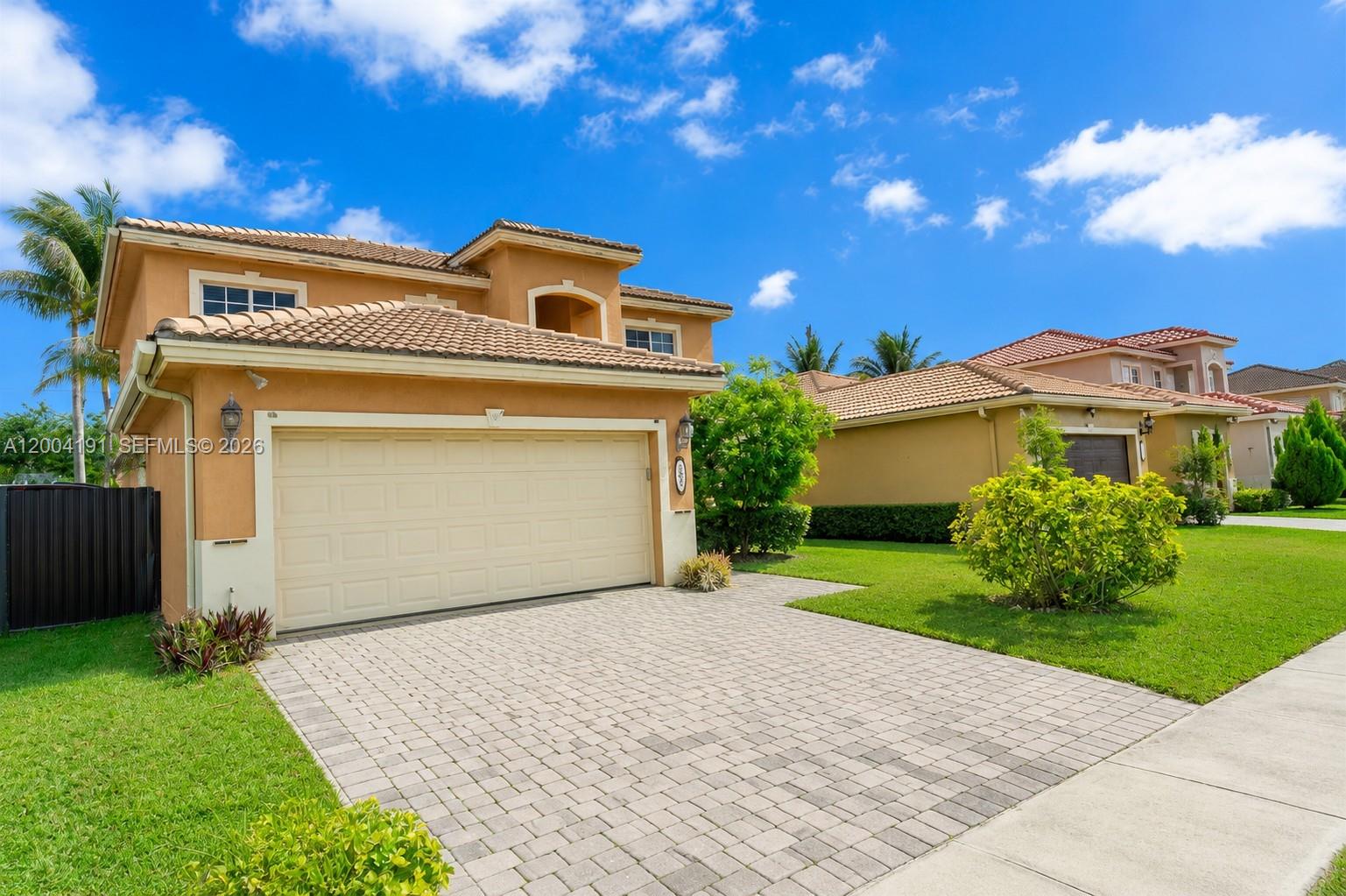 A two-story stucco house with a tiled roof and a paved driveway — 9031 SW 208th Ter, Cutler Bay FL 33189, CUTLER BAY, FL