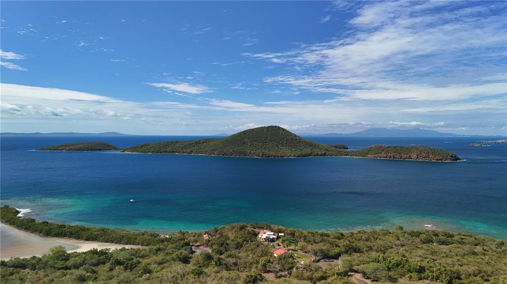 An aerial view shows a coastal landscape with a house overlooking a large island offshore — 3a BARRIO FLAMENCO TAMARINDO BEACH, CULEBRA, PR