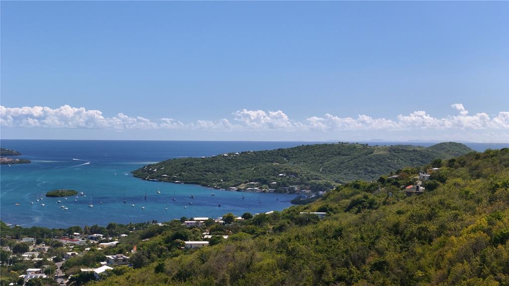 A high-angle view shows a coastal bay with boats, hills, and scattered houses — 3a BARRIO FLAMENCO TAMARINDO BEACH, CULEBRA, PR