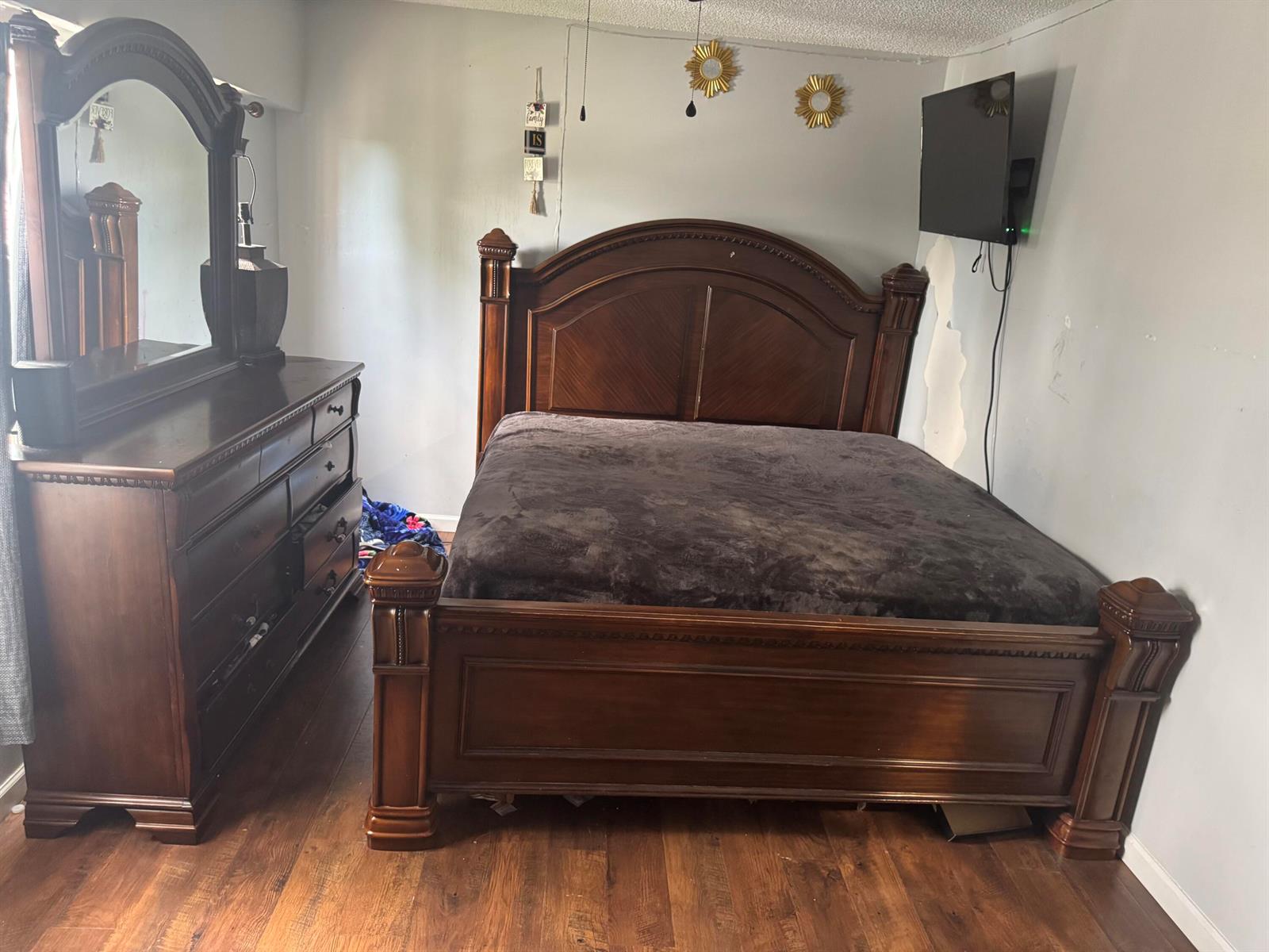 A bedroom features a dark wood bed frame and matching dresser with a mirror — 1234 White Pine Drive, Wellington FL 33414, WELLINGTON, FL