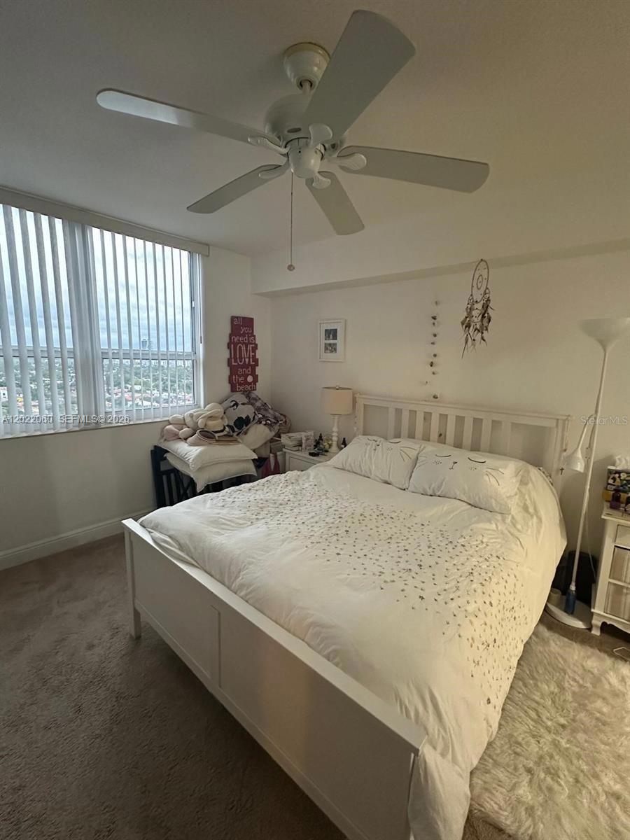 A bedroom features a white bed frame, a ceiling fan, and a window with blinds — 3232 SW 22nd Ter # 1607, Miami FL 33145, MIAMI, FL