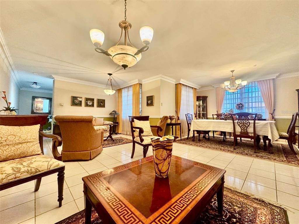 A living and dining area features tile floors, two chandeliers, and a wooden coffee table — 2 St. ESTANCIAS DEL LAGO UNIT D-4, CAGUAS, PR