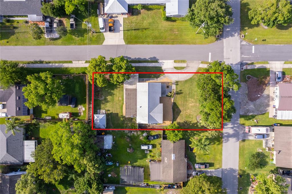 An aerial view shows a residential property with a house and yard outlined in red — 437 OREGON AVENUE, ST CLOUD, FL