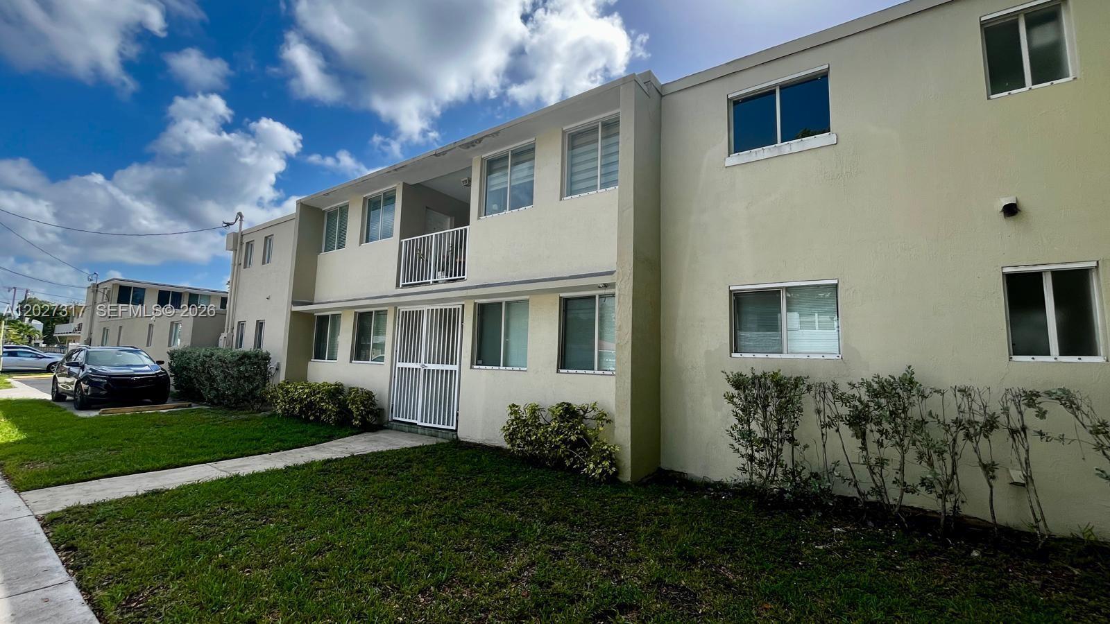A two-story apartment building with a white security gate and a small balcony — 1025 SW 7th Ave # 5, Miami FL 33130, MIAMI, FL