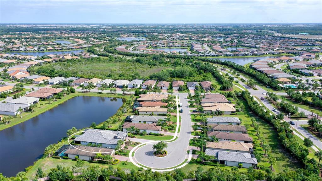 An aerial view shows a residential neighborhood with a circled house near a cul-de-sac — 7636 KIRKLAND COVE, LAKEWOOD RANCH, FL