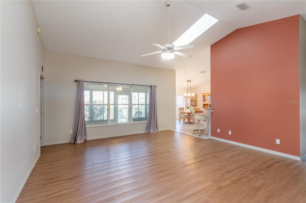 A single-story house with a light-colored exterior, a dark roof, and a manicured lawn — 5011 NW 31ST STREET, OCALA, FL