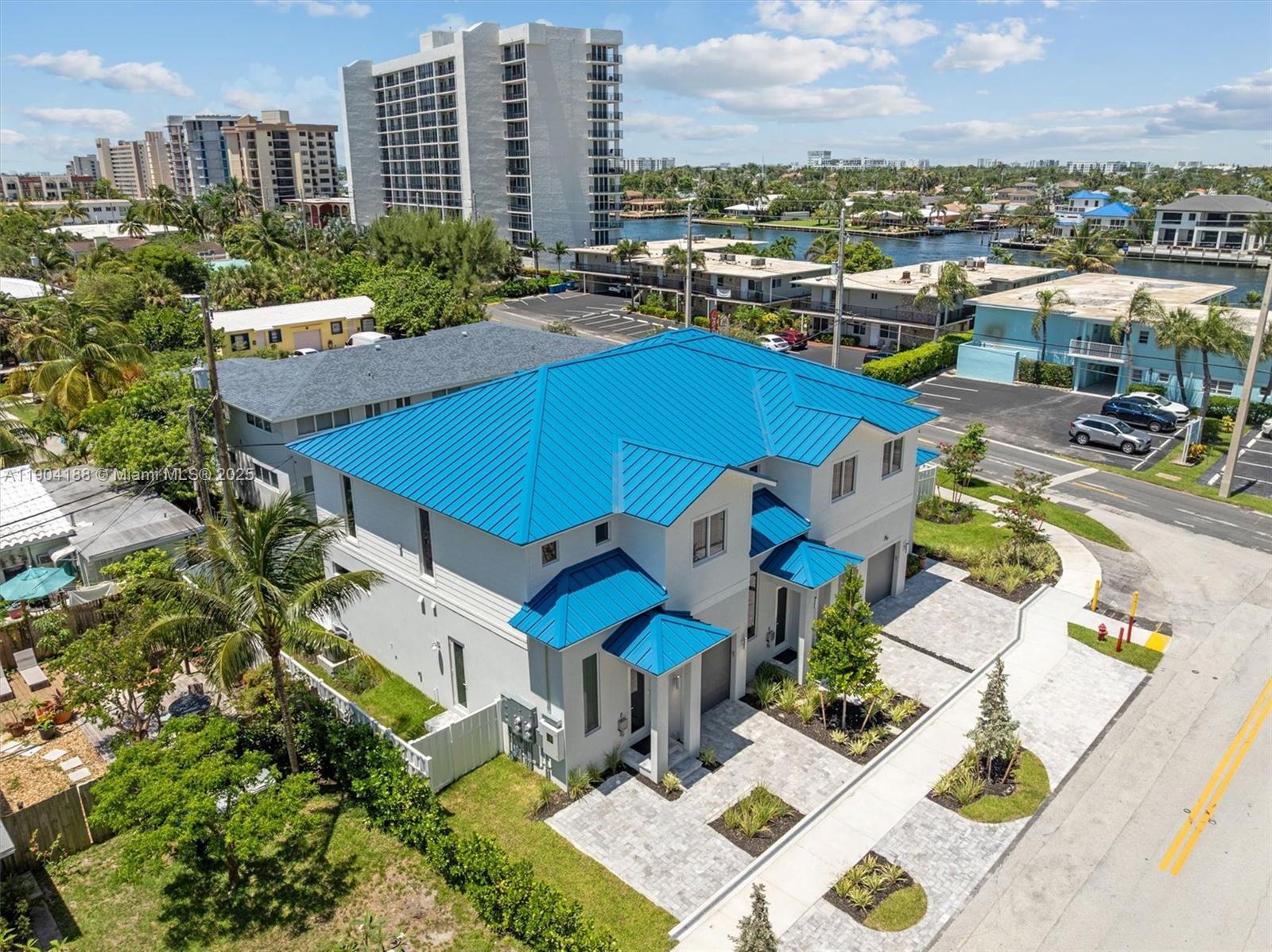 An aerial view shows a two-story house with a bright blue metal roof — 554 N Riverside Dr # B, Pompano Beach FL 33062, POMPANO BEACH, FL