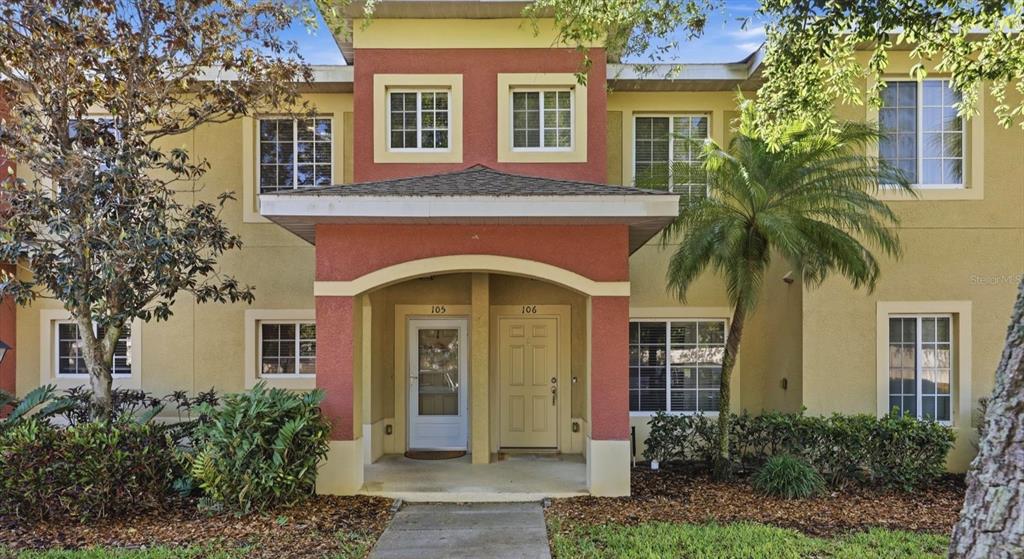A two-story building exterior features a covered entryway with two doors numbered 105 and 106 — 3903 45TH TERRACE W UNIT 106, BRADENTON, FL