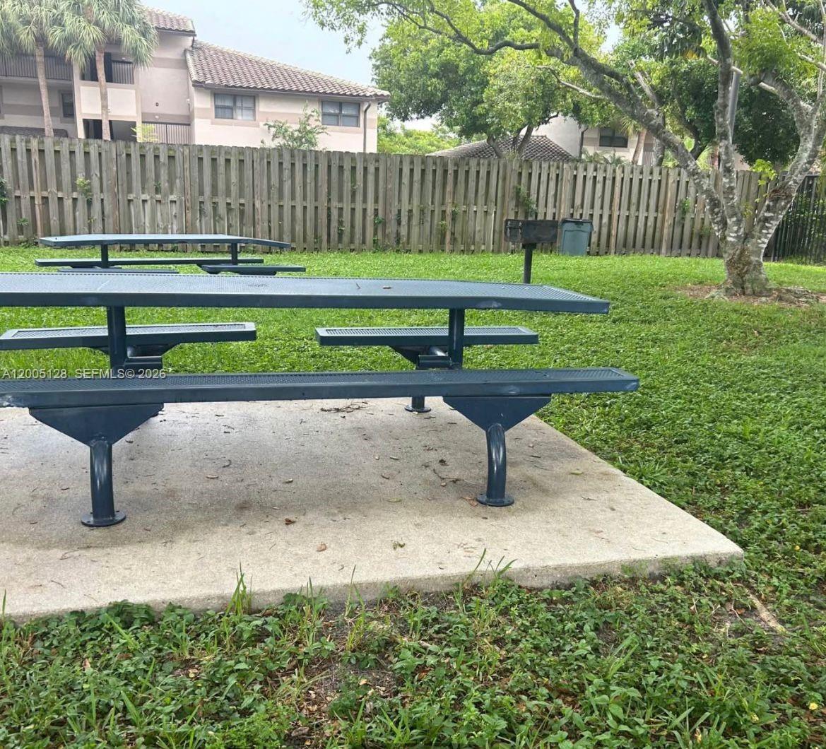 A metal picnic table sits on a concrete pad in a grassy outdoor area — 9926 Nob Hill Ct # 9926, Sunrise FL 33351, SUNRISE, FL