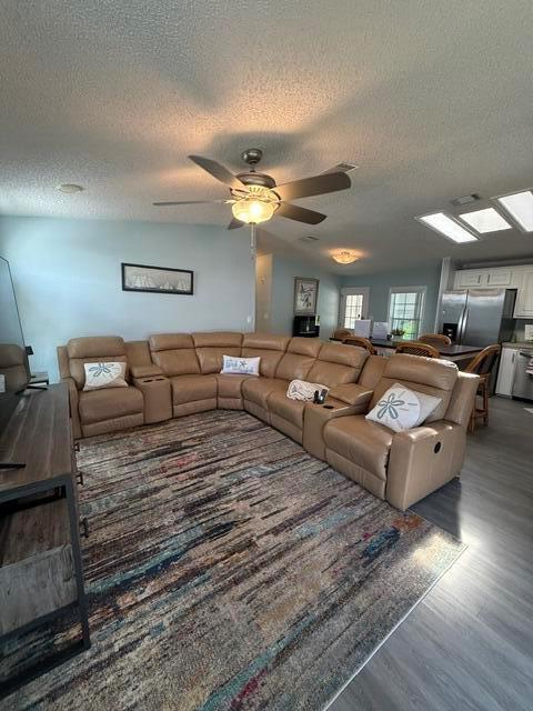 A living room features a large tan sectional sofa on a colorful patterned area rug — 400 N N Highway A1a Highway Lot 64, Jupiter FL 33477, JUPITER, FL
