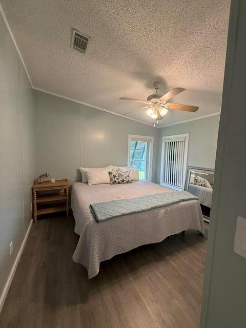 A bedroom features light blue walls, a ceiling fan, and a bed with a quilt — 400 N N Highway A1a Highway Lot 64, Jupiter FL 33477, JUPITER, FL