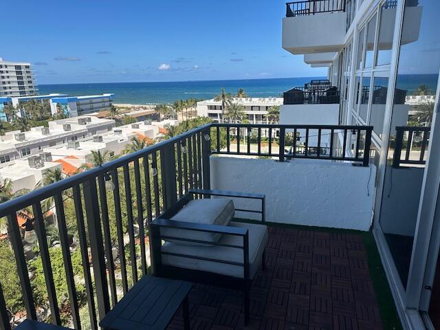 A balcony with dark wood-look flooring, a lounge chair, and a view of the ocean — 531 N Ocean Boulevard # 903, Pompano Beach FL 33062, POMPANO BEACH, FL