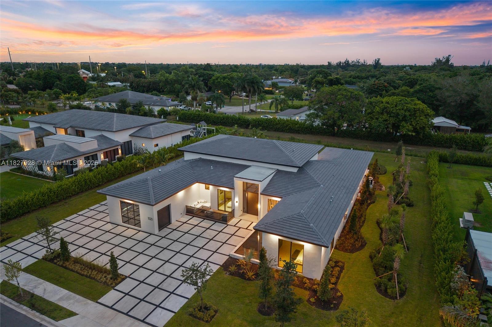 An aerial view shows a modern single-story house with a tiled roof and paved driveway — 1520 SW 149th Ter, Davie FL 33326, DAVIE, FL