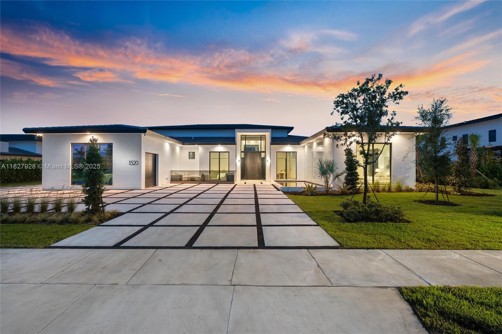 A modern single-story house with a white exterior, flat roof, and a paved driveway — 1520 SW 149th Ter, Davie FL 33326, DAVIE, FL