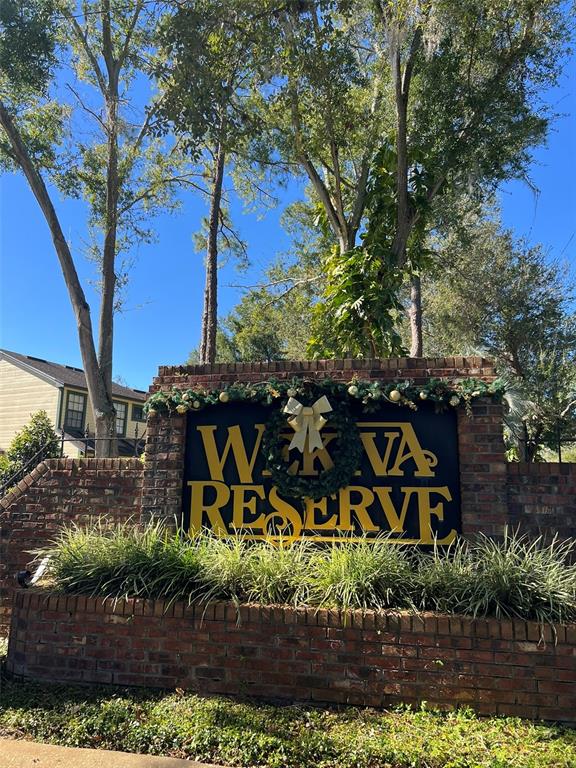 A brick monument sign for Wekiva Reserve stands in front of tall trees — 2906 CANDELA COURT, APOPKA, FL
