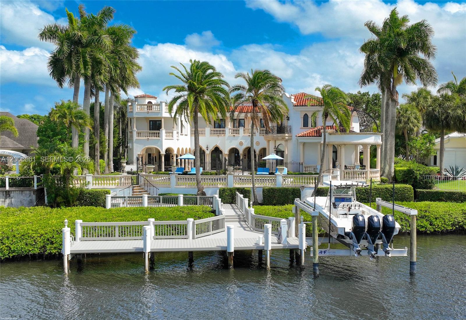 A large waterfront Mediterranean-style mansion features a private dock with a boat lift — 370 Eagle Dr, Jupiter FL 33477, JUPITER, FL