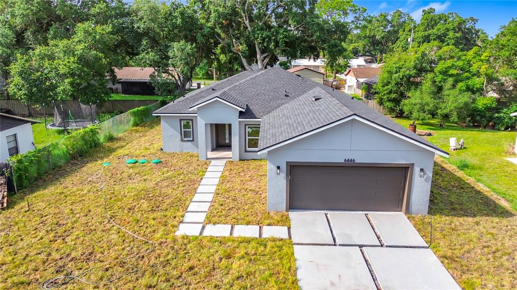 An aerial view shows a single-story gray house with a two-car garage and lawn — 6446 FALL STREET, ST CLOUD, FL