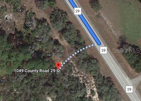 This is a satellite map view showing a property location along a road — 1049 COUNTY ROAD 29, LAKE PLACID, FL