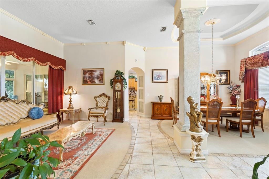 A formal dining room features a wooden table, chairs, a hutch, and a stone pillar — 1621 TIMBER HILLS DRIVE, DELAND, FL