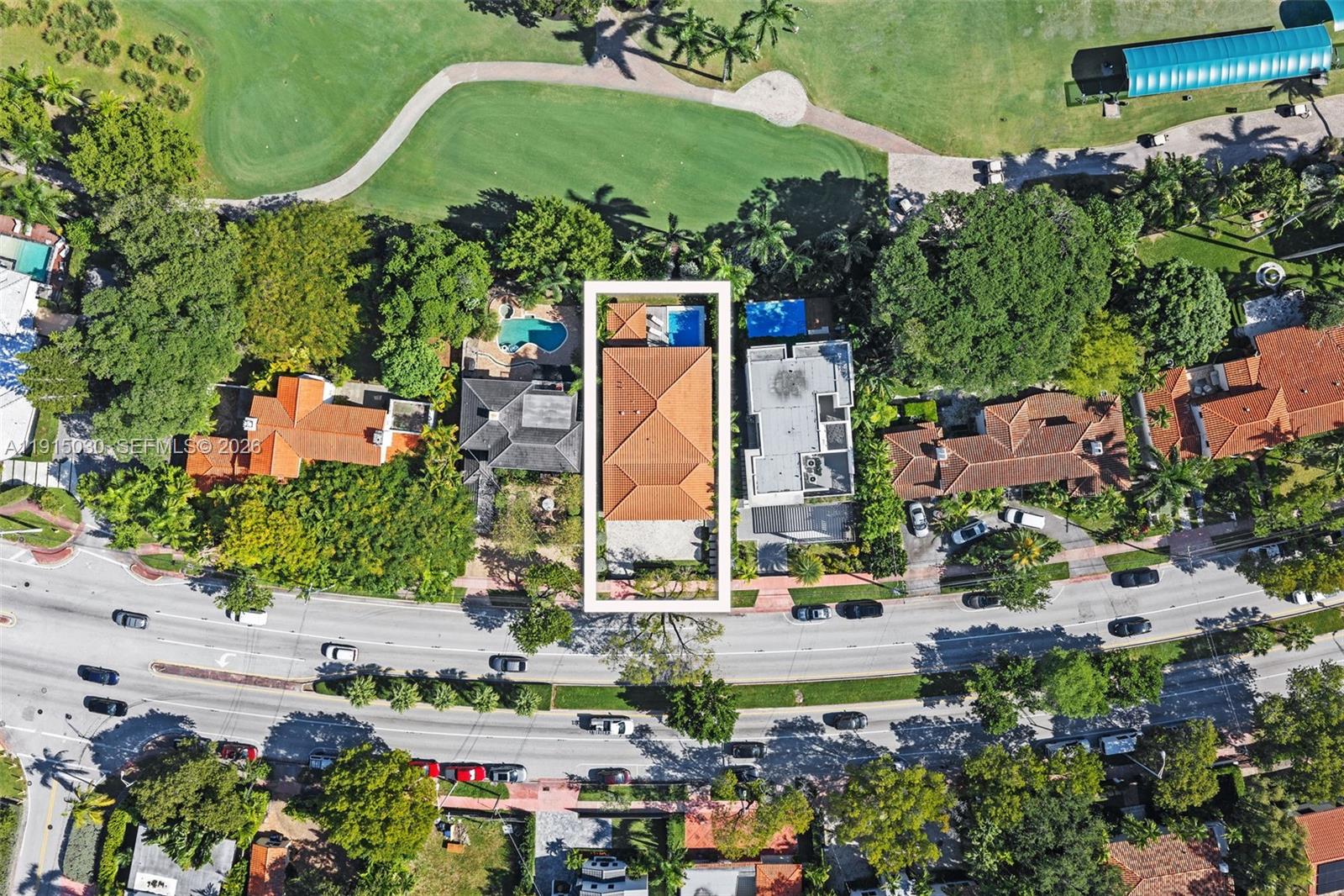 Aerial view of a residential property with a tiled roof and pool near a golf course — 5831 Alton Rd, Miami Beach FL 33140, MIAMI BEACH, FL