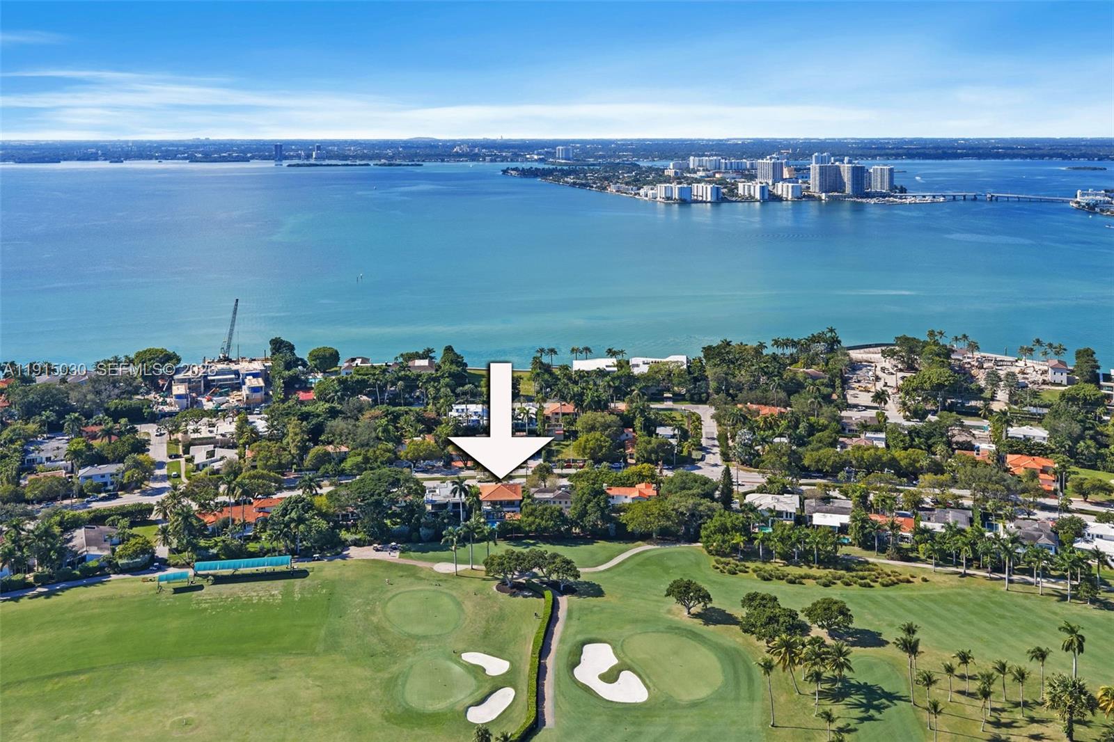 An aerial view shows a house with a red roof overlooking a golf course — 5831 Alton Rd, Miami Beach FL 33140, MIAMI BEACH, FL