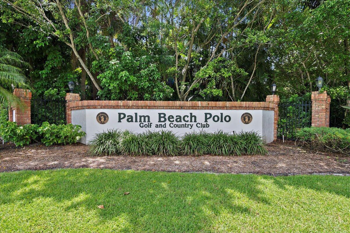 A brick-trimmed sign for the Palm Beach Polo Golf and Country Club stands outdoors — 11863 Wimbledon Circle # 441, Wellington FL 33414, WELLINGTON, FL