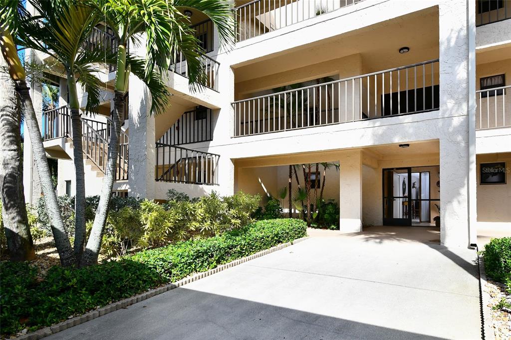 An exterior view of a multi-story apartment building with balconies and a ground-level entrance — 1610 N ISLAMORADA BOULEVARD UNIT 62A, PUNTA GORDA, FL
