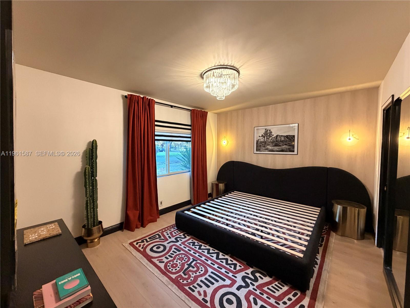 A bedroom features a black platform bed, a patterned rug, and red curtains — 920 SW 50th Ave, Plantation FL 33317, PLANTATION, FL