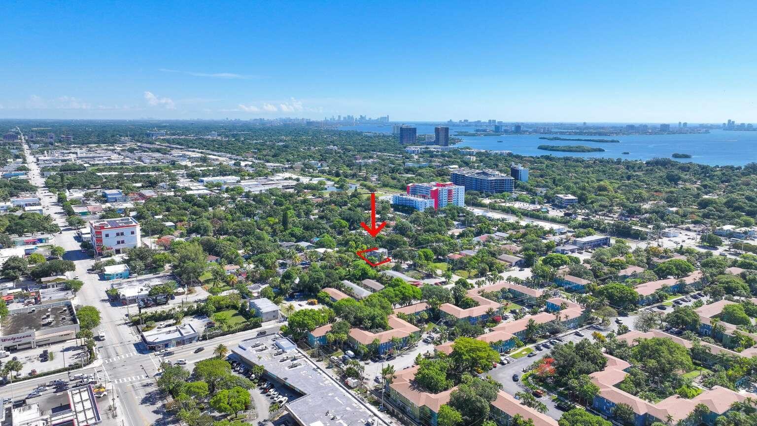 An aerial view shows a residential neighborhood with a red arrow pointing to a property — 295 NE 55th Street, Miami FL 33137, MIAMI, FL
