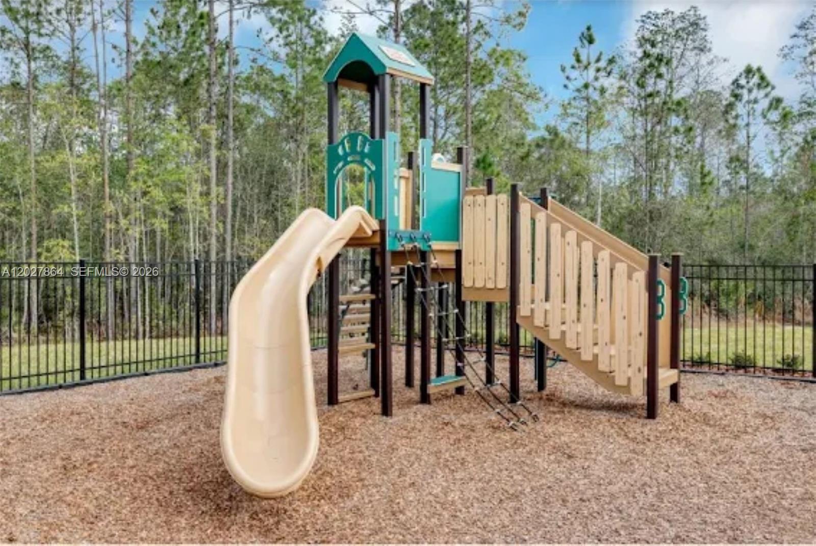 A beige house exterior features a two-car garage, a shingled gable, and a concrete driveway — 1122 Cabot Cliffs Dr, Daytona FL 32124, DAYTONA, FL