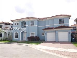 A two-story blue house with a tiled roof and a two-car garage — 15650 SW 11th Ter # 0, Miami FL 33194, MIAMI, FL