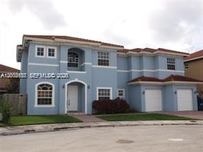 A two-story light blue house with a tiled roof and two attached garages — 15650 SW 11th Ter # 0, Miami FL 33194, MIAMI, FL