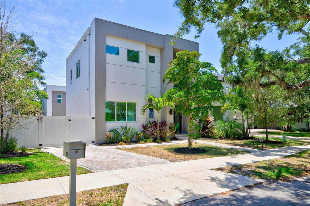 A modern two-story house with a flat roof, white facade, and a paved driveway — 2430 FLOYD STREET, SARASOTA, FL