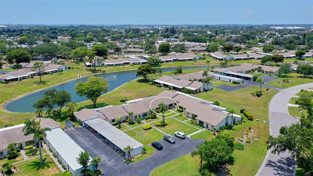 An aerial view shows a single-story residential building with a central courtyard and parking area — 6129 HERITAGE LANE W UNIT 6129, BRADENTON, FL