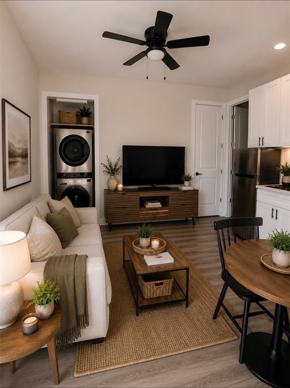 A living room features a sofa, television, coffee table, and an integrated laundry closet — 1433 GRAND PALM DRIVE, ORLANDO, FL