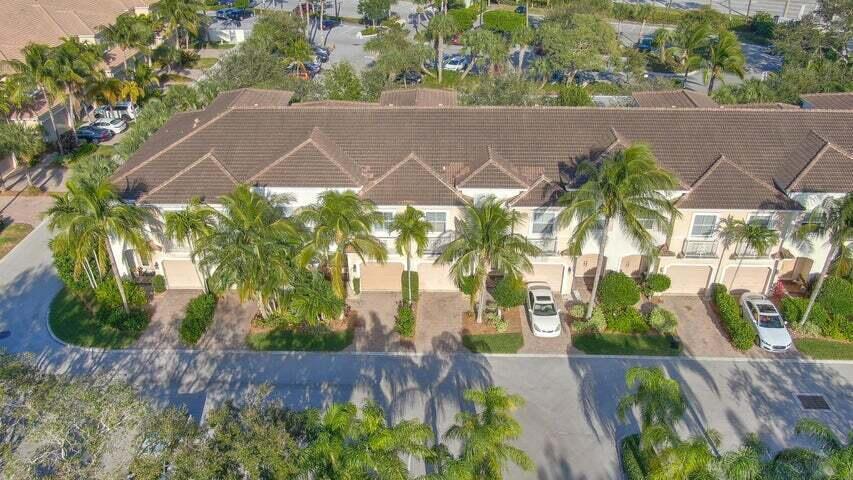 An aerial view shows a row of multi-story townhouses with brown roofs and palm trees — 1000 Us-1 # 805, Jupiter FL 33477, JUPITER, FL