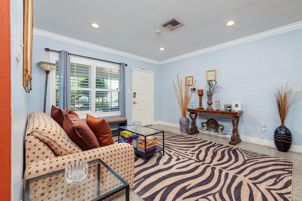 A living room features a zebra-print rug, a patterned sofa, and a glass coffee table — 145 SE 3rd Avenue, Boynton Beach FL 33435, BOYNTON BEACH, FL