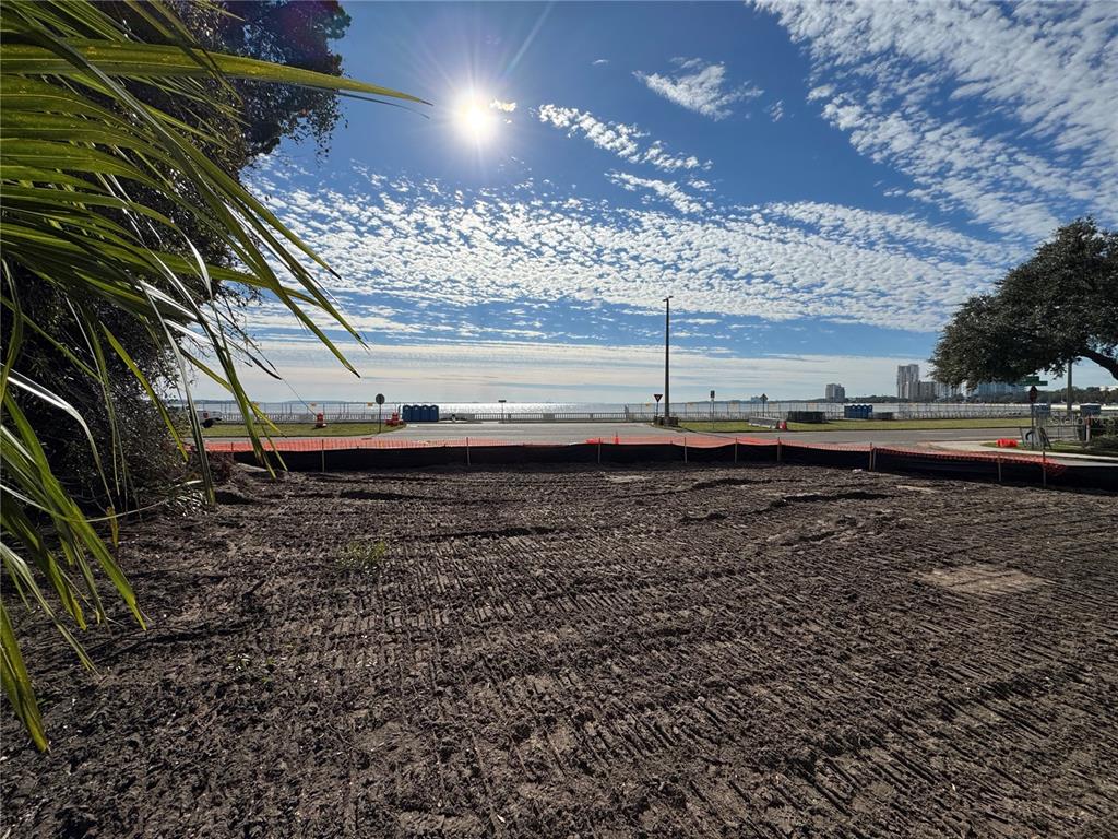 A vacant, cleared dirt lot overlooks a coastal road and the ocean under a sunny sky — 2715 BAYSHORE BOULEVARD, TAMPA, FL