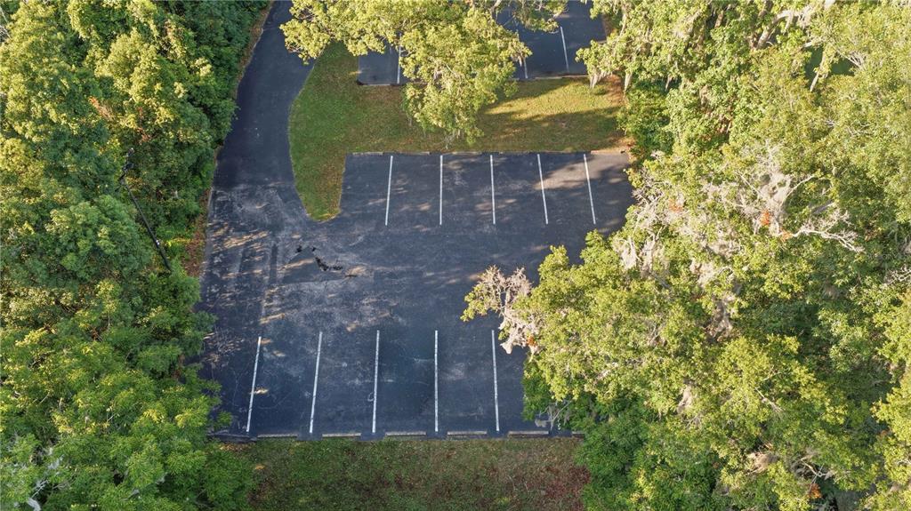 An aerial view of an asphalt parking lot surrounded by trees — TBD NE 3RD STREET, OCALA, FL