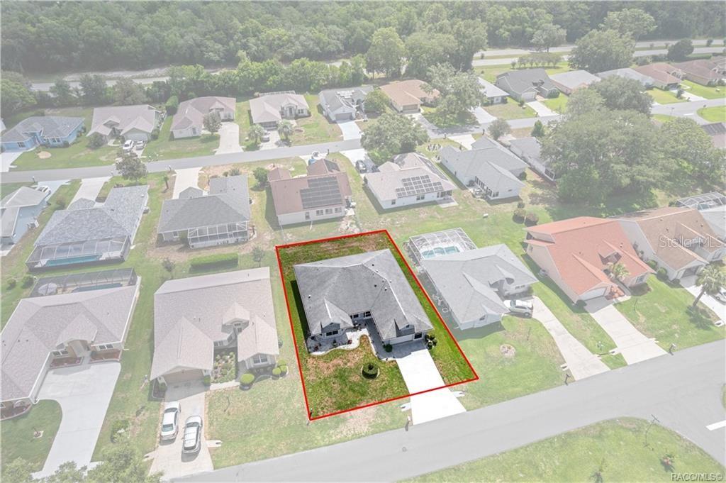 An aerial view shows a single-story house with a gray roof and a front lawn — 4271 N STEWART WAY, BEVERLY HILLS, FL
