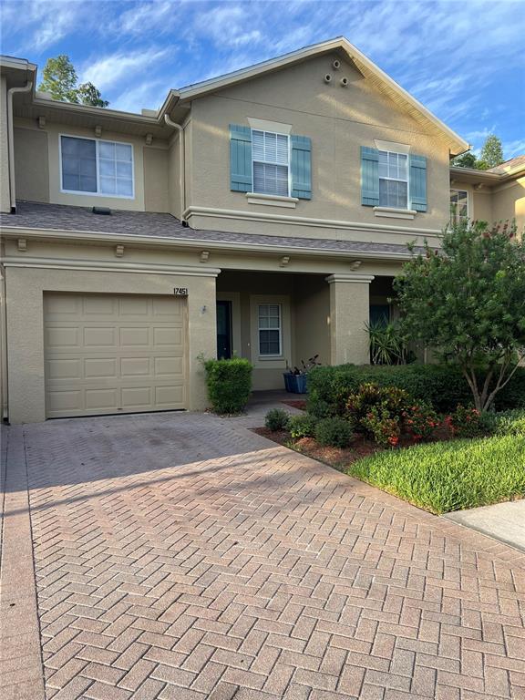 A kitchen with white cabinets, light tile flooring, and a view into a dining area — 17451 HUGH LANE, LAND O LAKES, FL
