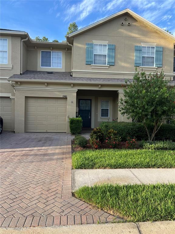 A bedroom with light blue walls, brown carpet, a ceiling fan, and an open closet — 17451 HUGH LANE, LAND O LAKES, FL