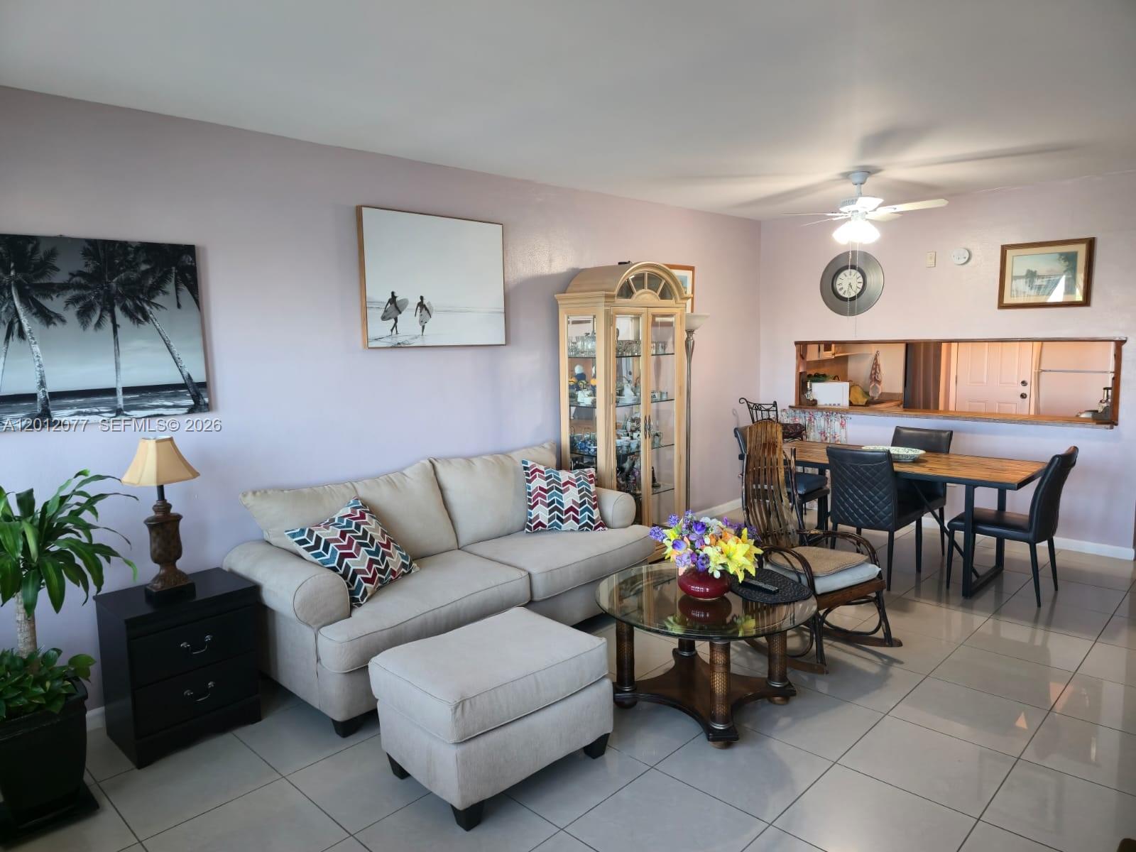 A living and dining area features light-colored tile floors, a beige sofa, and a hutch — 18707 NE 14th Ave # 727, Miami FL 33179, MIAMI, FL