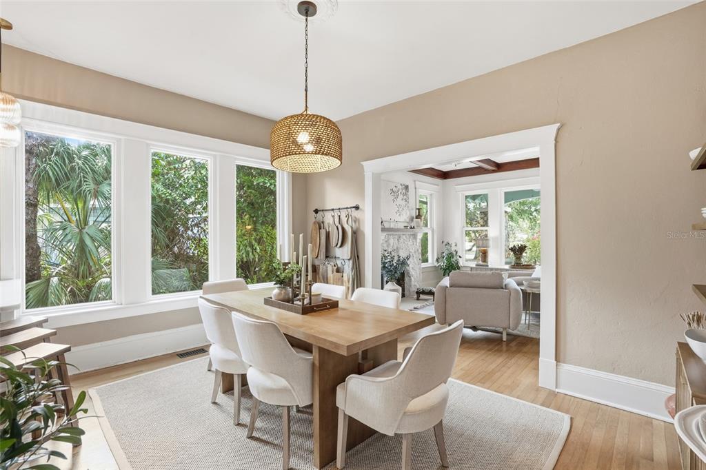 A dining room with a wooden table, upholstered chairs, and a woven pendant light fixture — 1473 BARCELONA AVENUE, FORT MYERS, FL