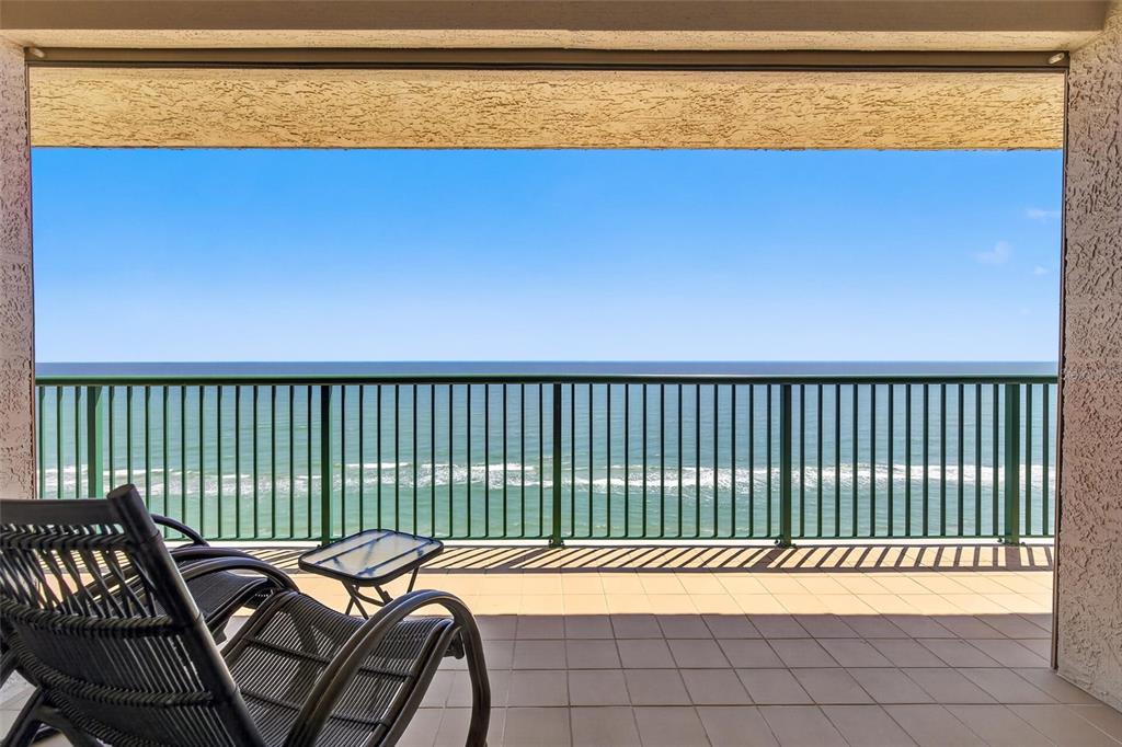 A balcony with tile flooring, a metal railing, and a view of the ocean — 3315 S ATLANTIC AVENUE UNIT 1406, DAYTONA BEACH SHORES, FL